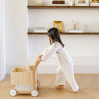 Ivory@lifestyle image of girl playing with a shopping trolley