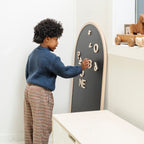 Beech@lifestyle image of little boy playing with the arched chalkboard
