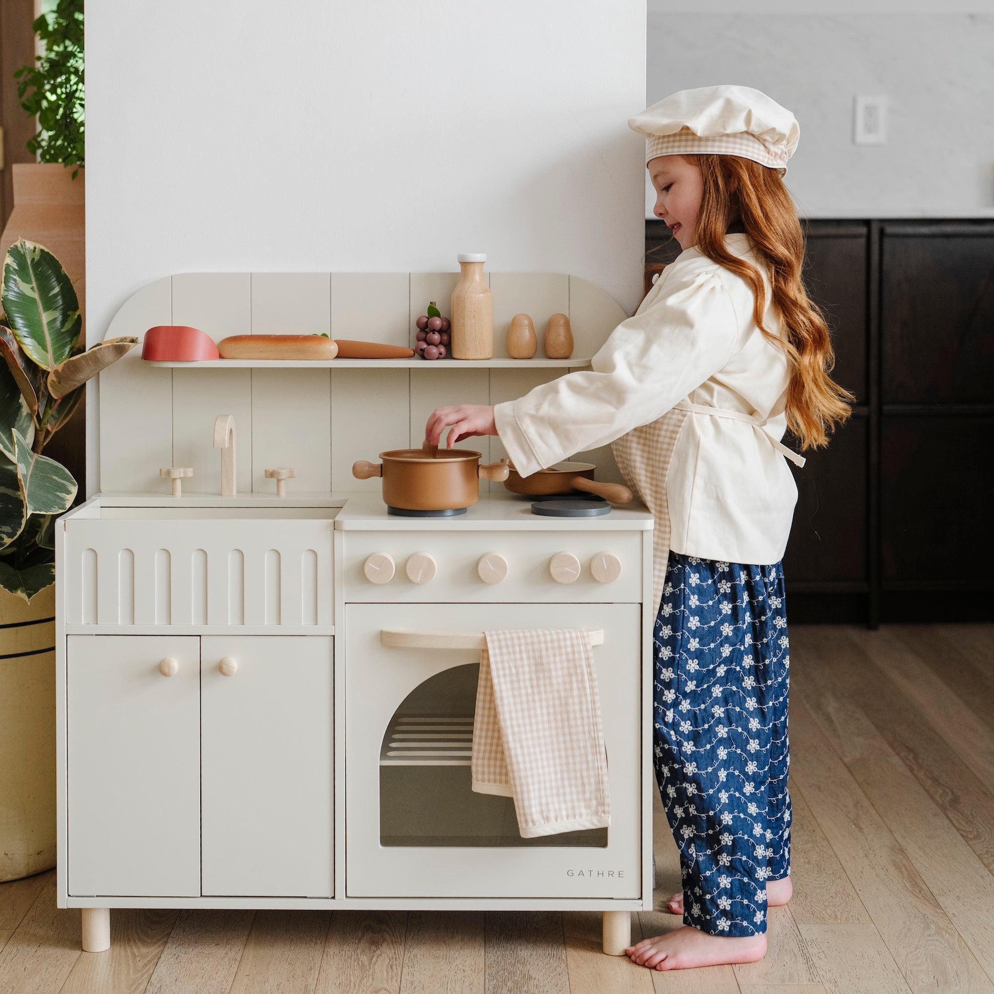 Ivory@Play Chef Dress-Up Set with a little girl and the play kitchen