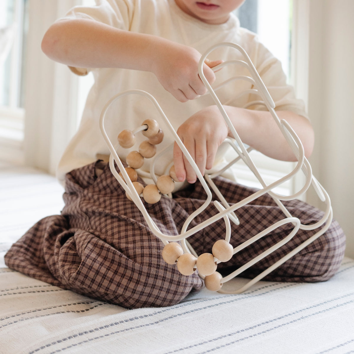 Ivory (on sale) / Square@Toddler engaging with bead maze to build hand-eye coordination