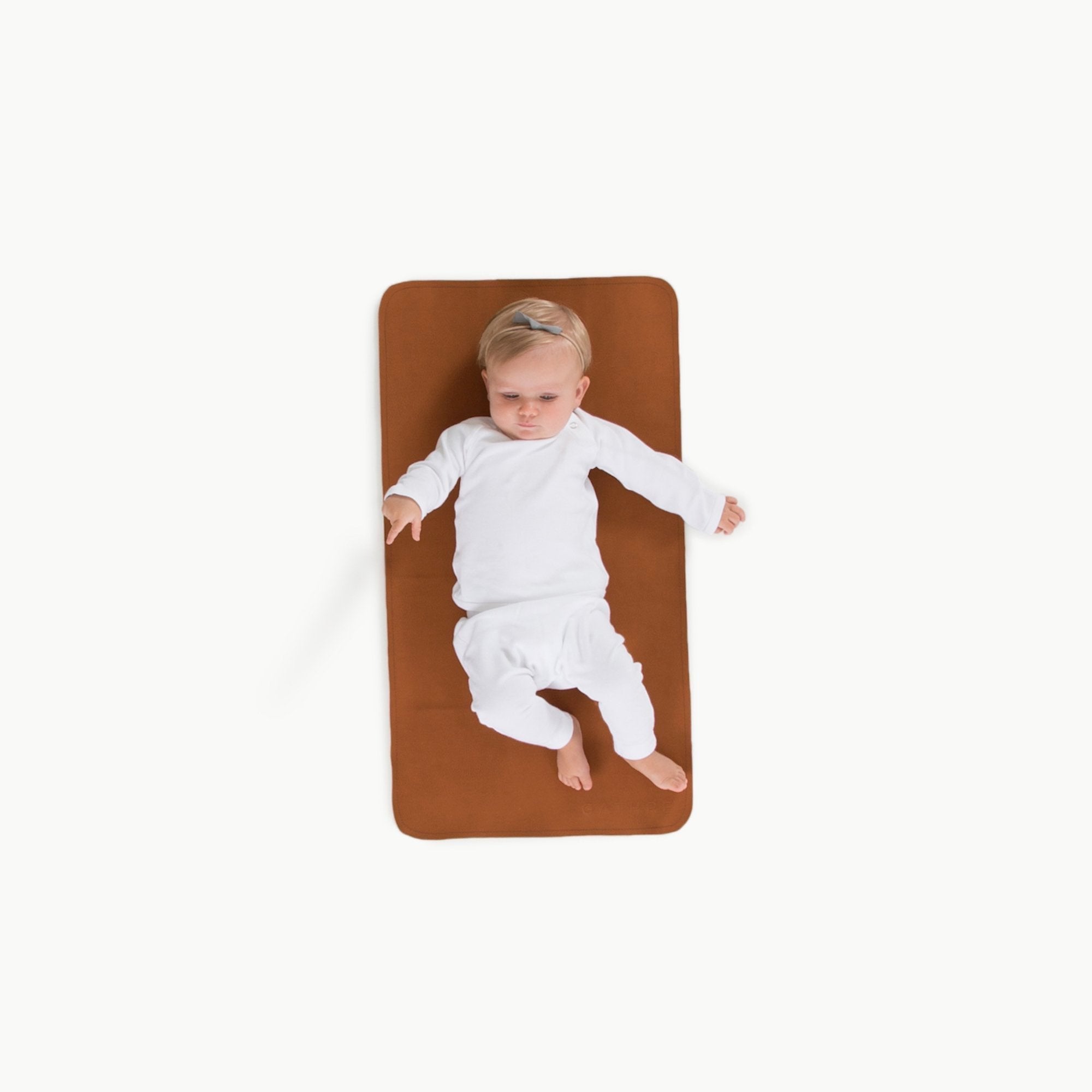 Ginger (on sale)@Overhead of baby laying on the Ginger Micro+ Mat