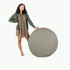 Grove (on sale)@Woman holding up the Grove Floor Cushion