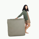 Grove (on sale) / Square@Woman holding the Grove Square Floor Cushion