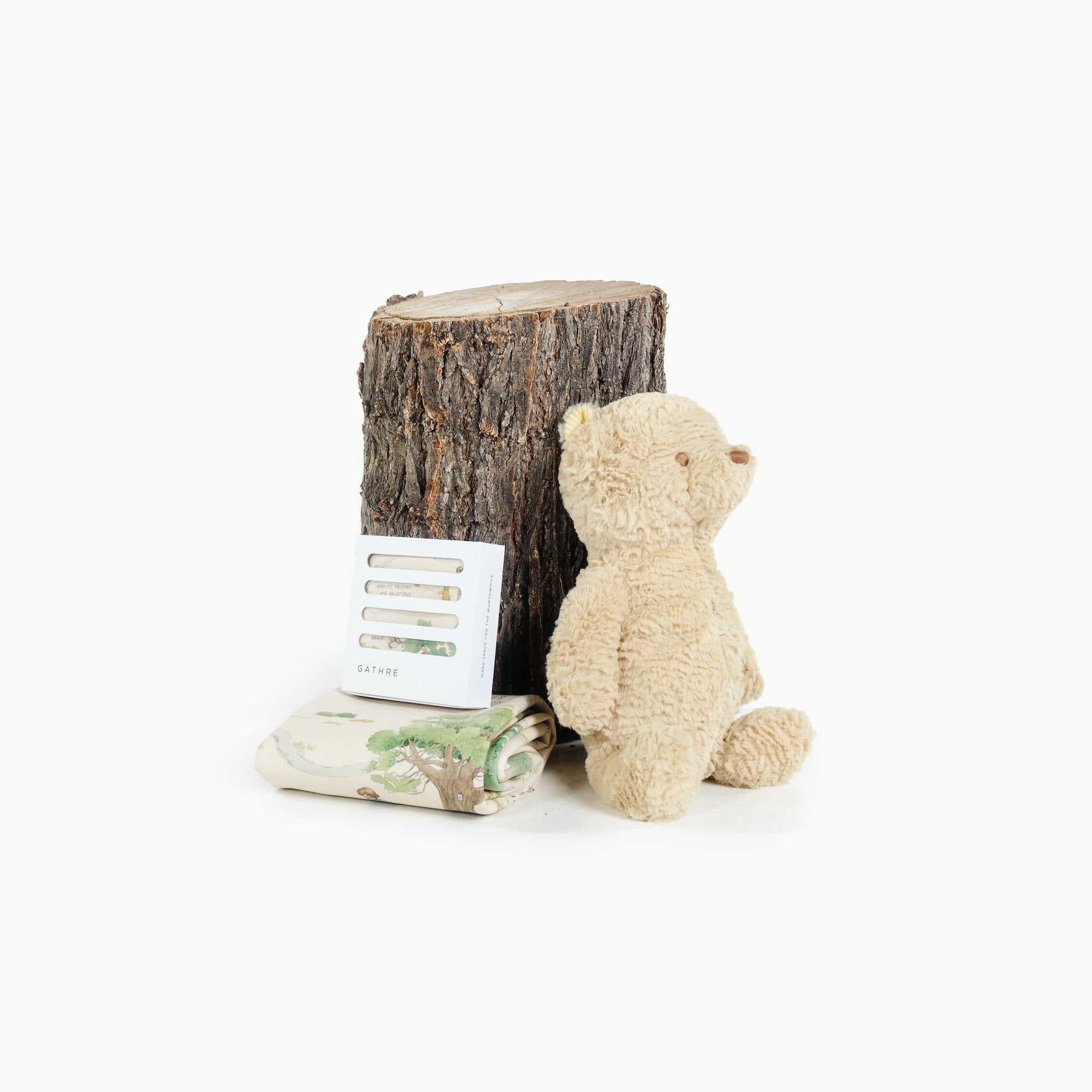 Hundred Acre Wood (on sale)@Hundred Acre Wood Mats leaning on a log near a teddy bear
