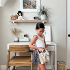 Millet (on sale)@Little girl near a desk wearing the Millet Children's Purse