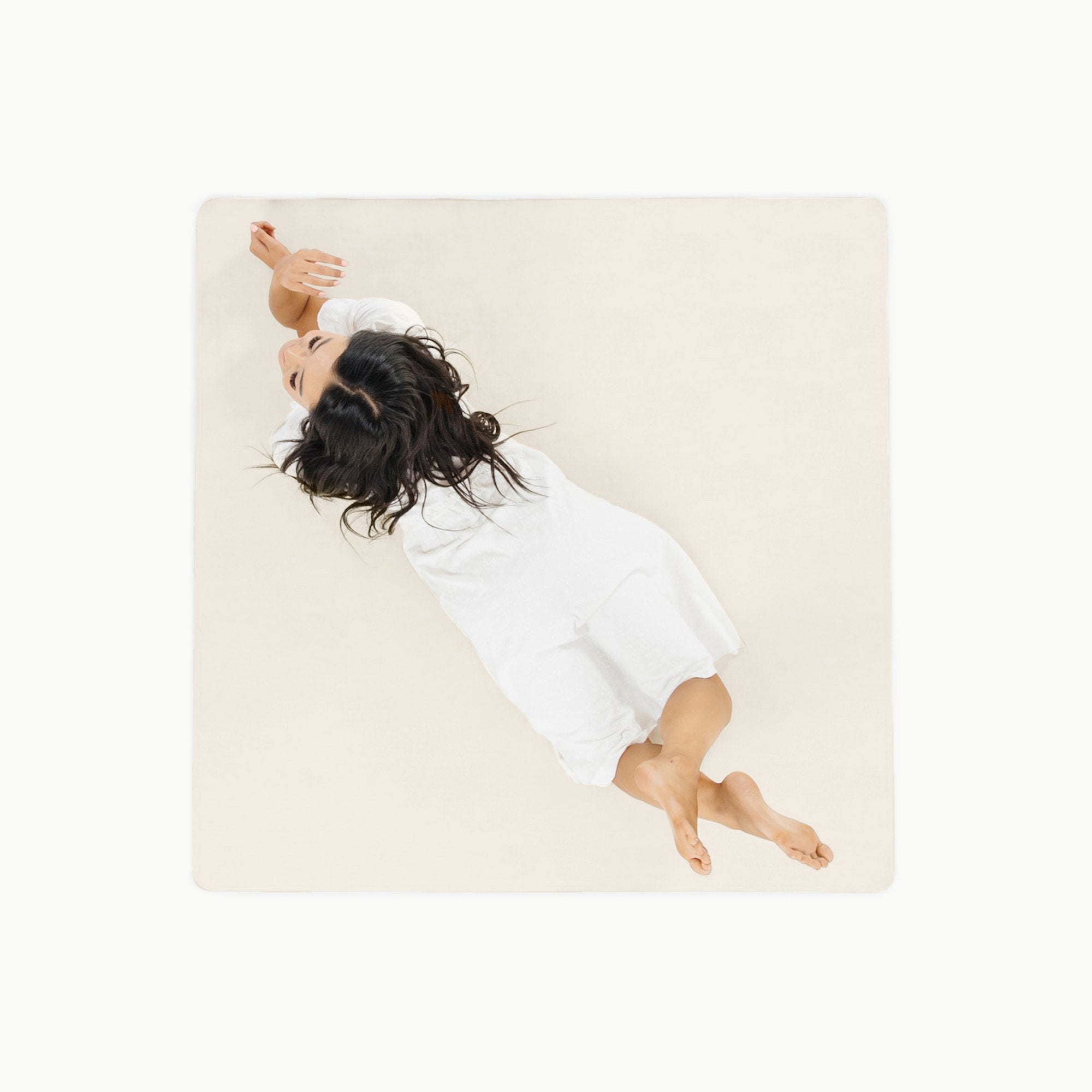 Ivory@overhead of woman laying on the ivory midi mat