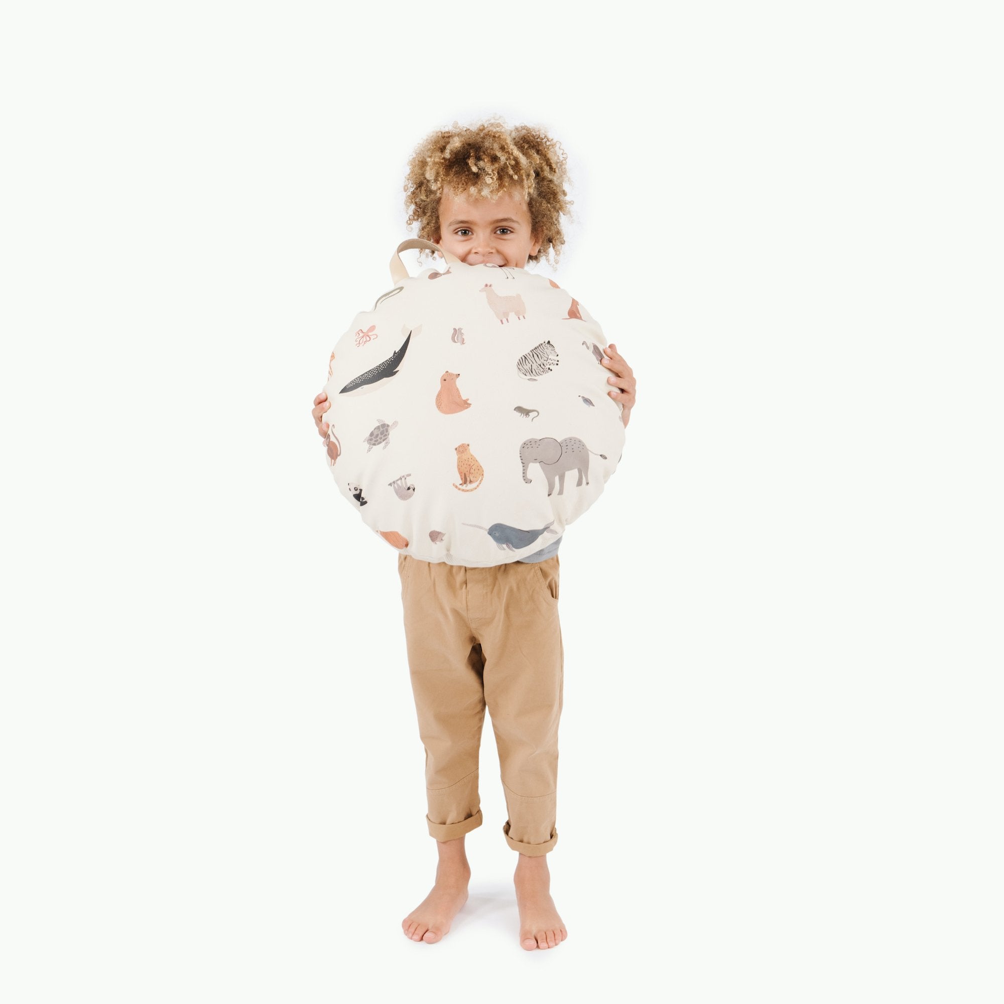 Menagerie / Circle@Kid holding the Menagerie Mini Circle Floor Cushion