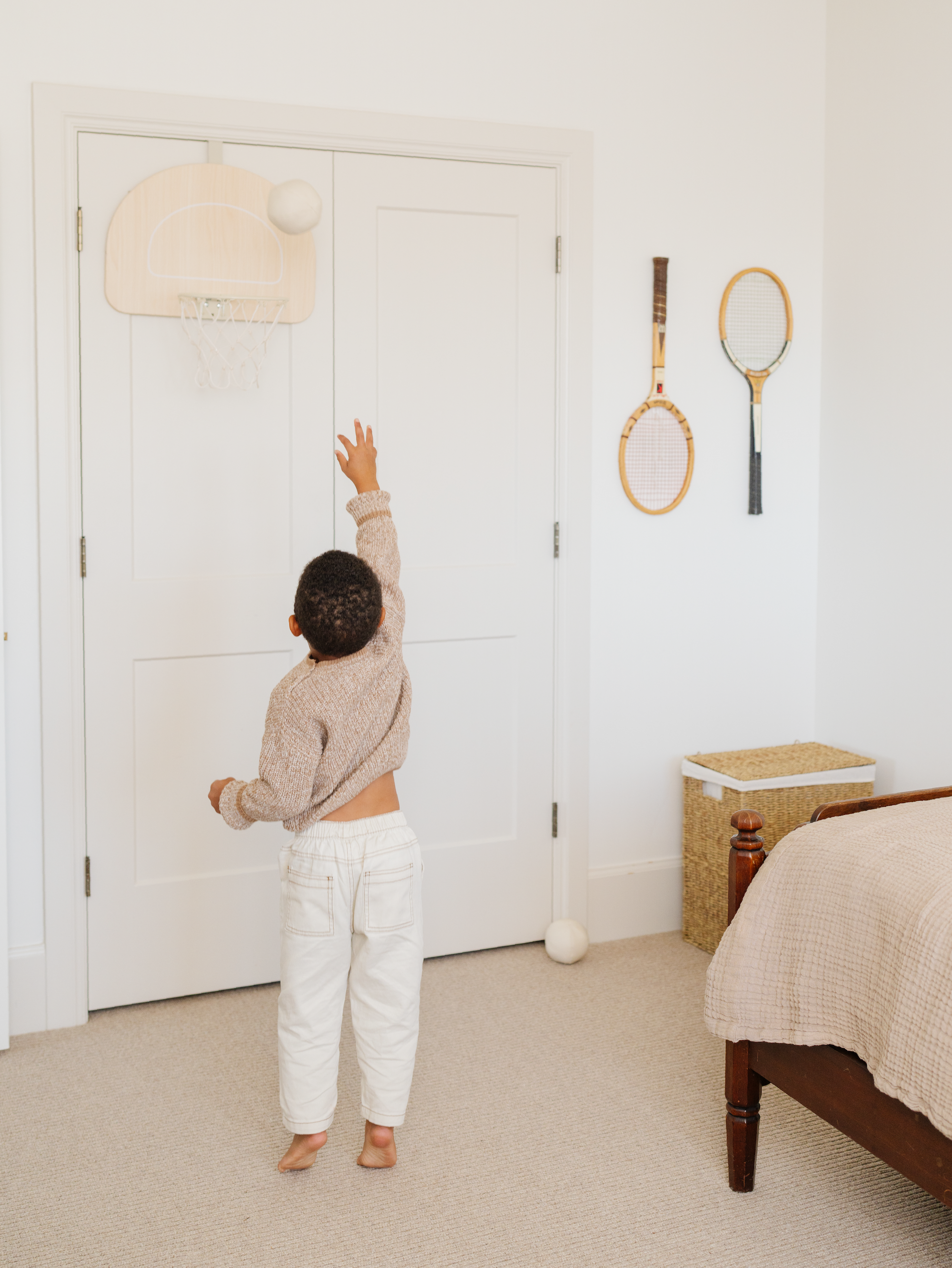 Kid playing on the Gathre Doorway Basketball Hoop.