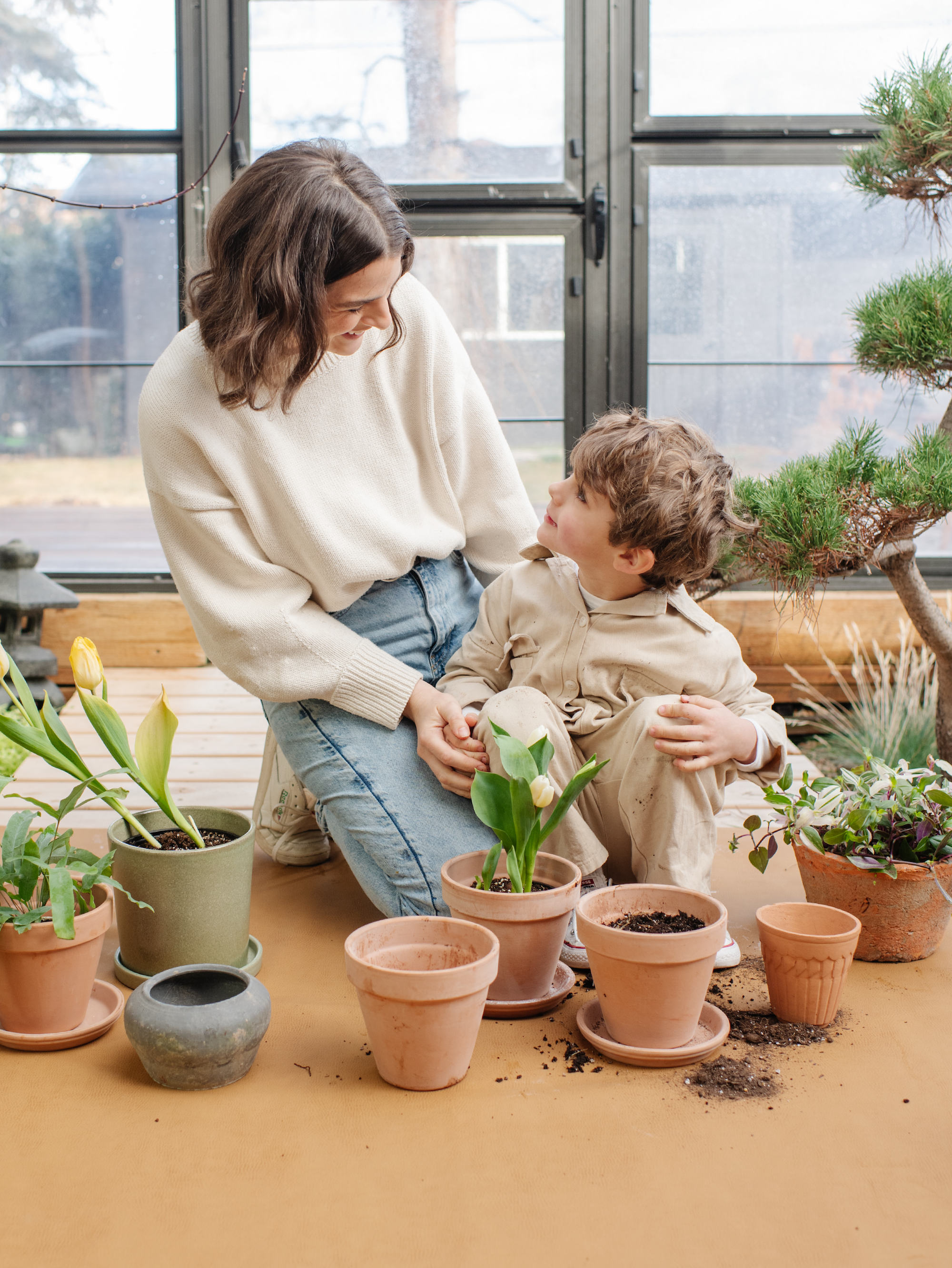 Mom + kid on a Gathre Mat gardening.