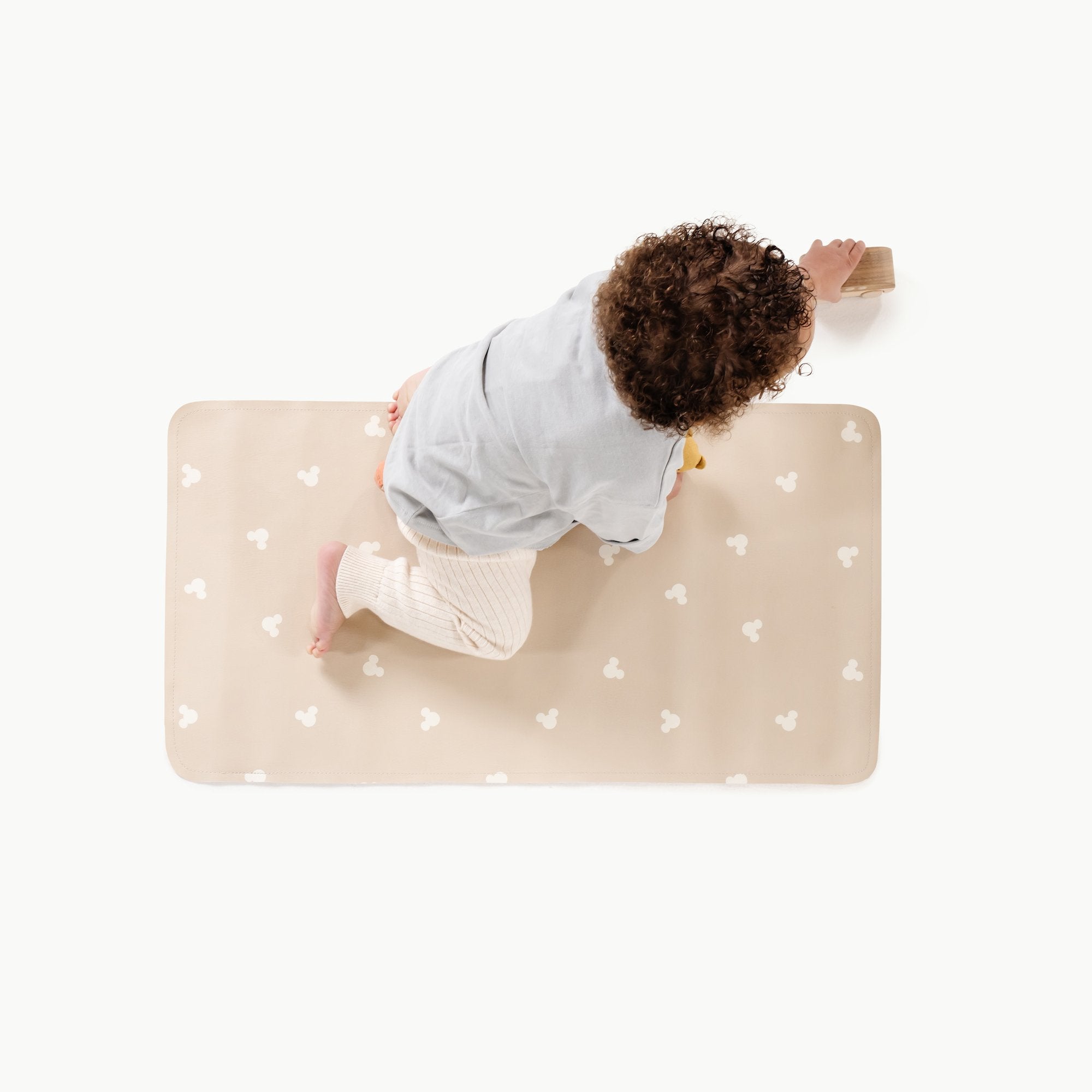 Mickey Mouse (on sale)@Overhead of baby sitting on the Mickey Mouse Micro+ Mat