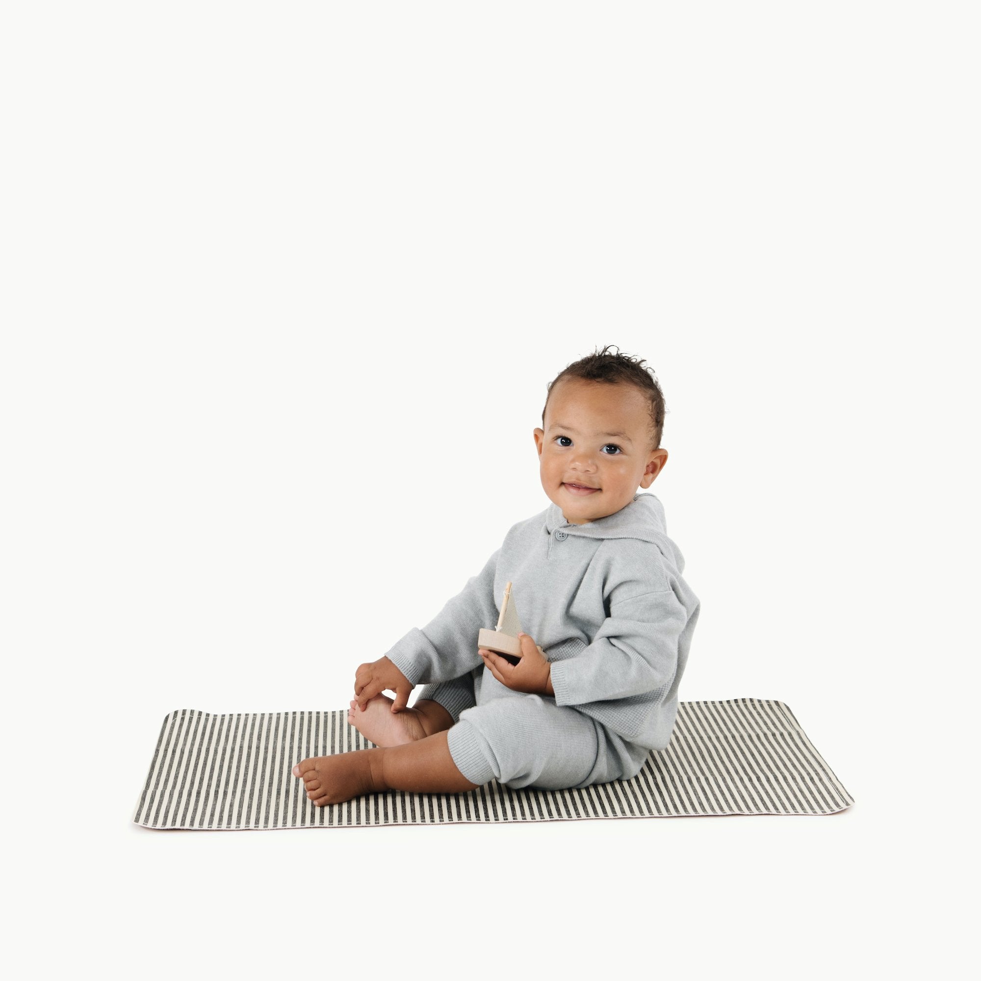 Stone Stripe@Baby sitting on the Stone Stripe Micro+ Mat