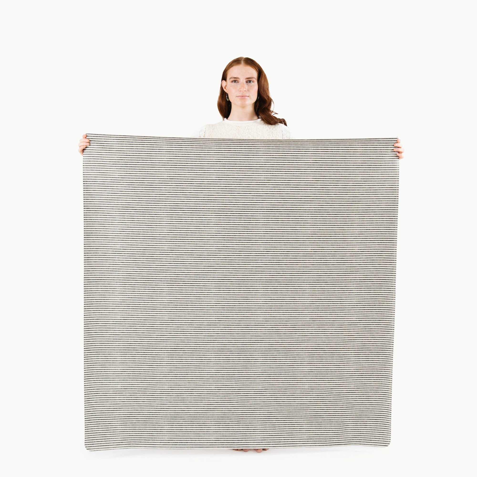 Stone Stripe / Square@Woman holding the Stone Stripe Midi Square Mat