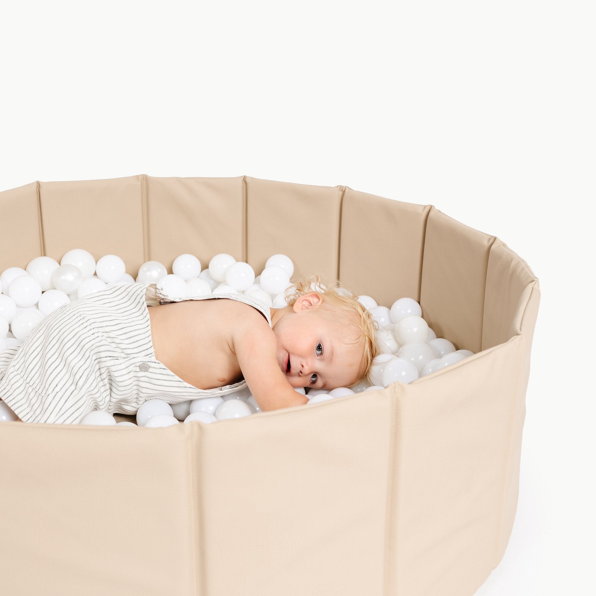 Millet@Kid playing in the millet ball pit