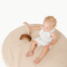 Millet / Circle@overhead of kid playing on the millet padded mini circle