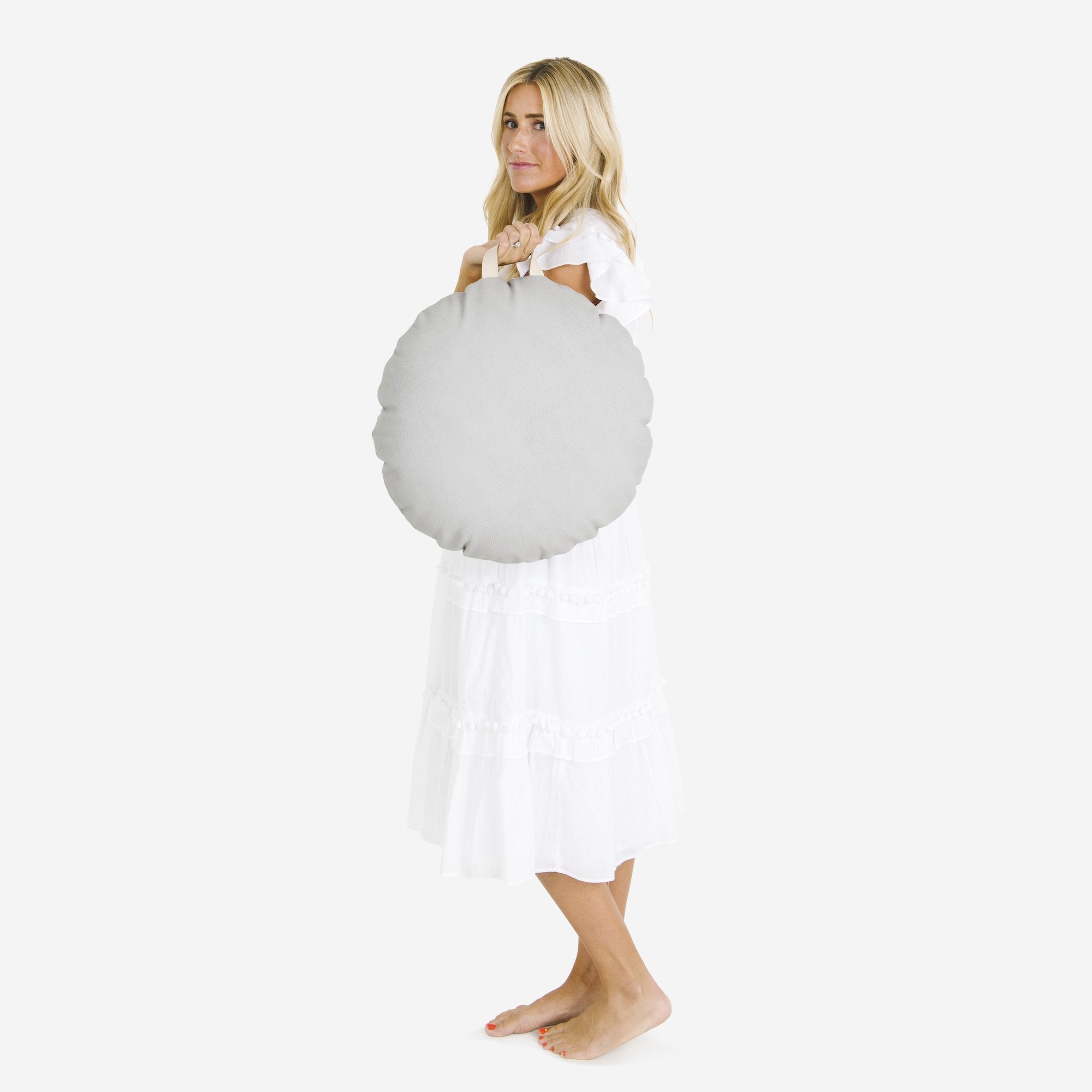 Pewter (on sale) / Circle@Woman holding the Pewter Circle Mini Floor Cushion