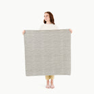 Stone Stripe / Mini@woman holding the mini stone stripe mat