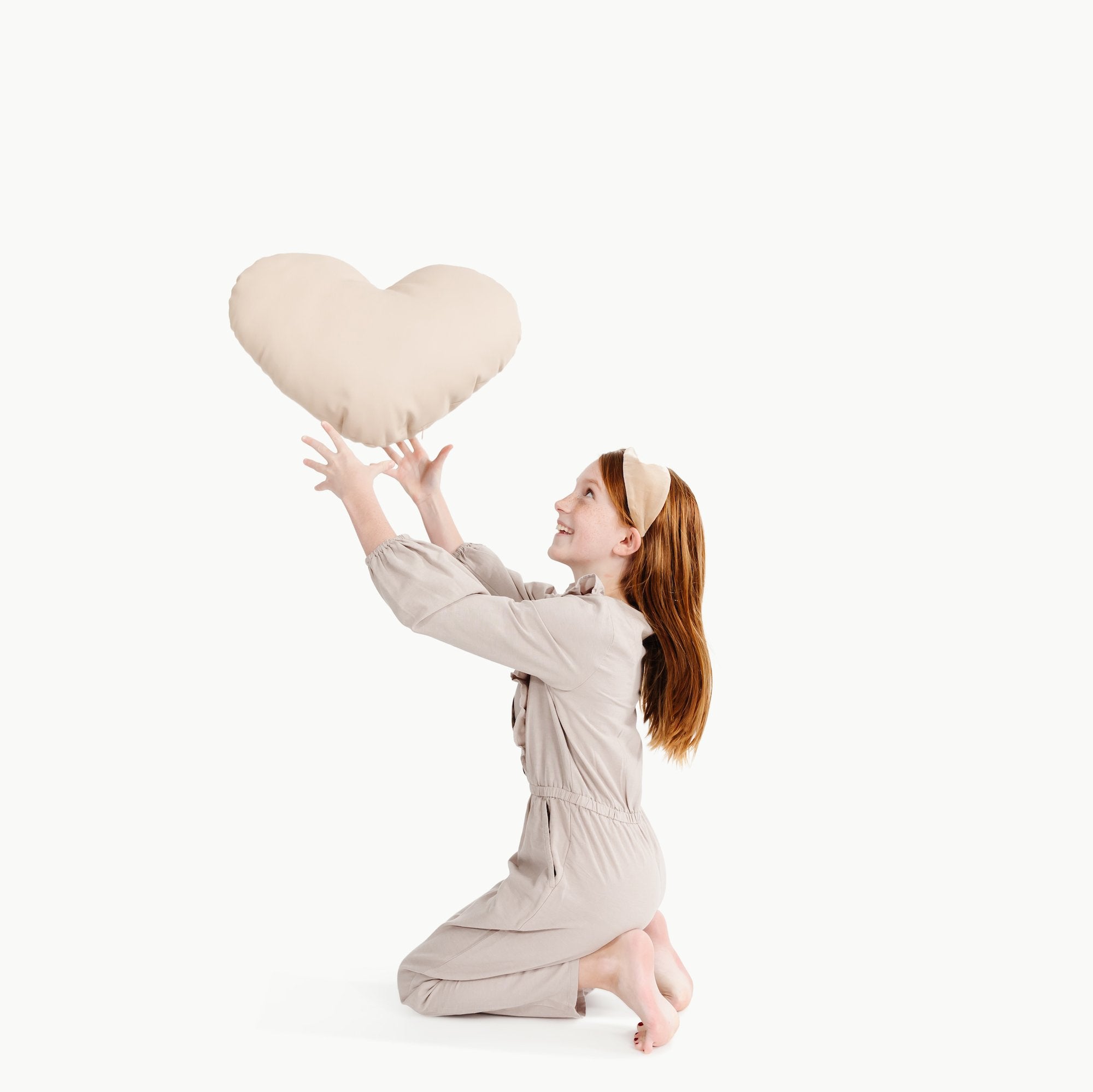 Paloma (on sale)@Kid holding the Paloma Heart Pillow