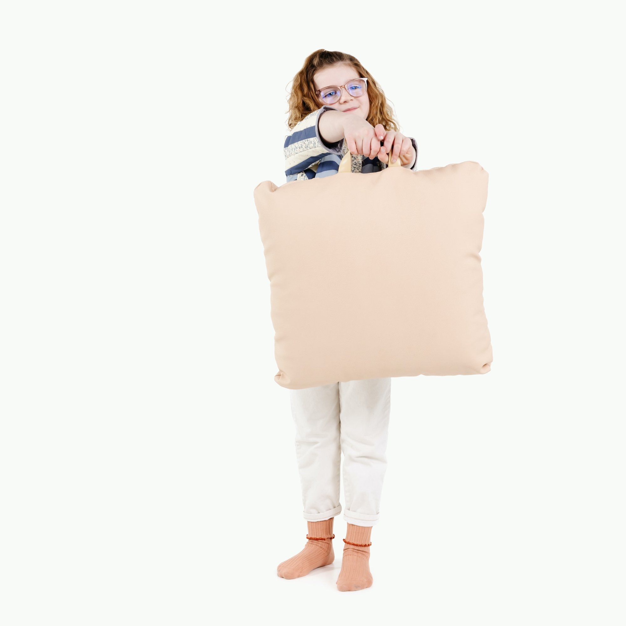 Pomelo (on sale) / Square@Kid holding the Pomelo Square Mini Floor Cushion