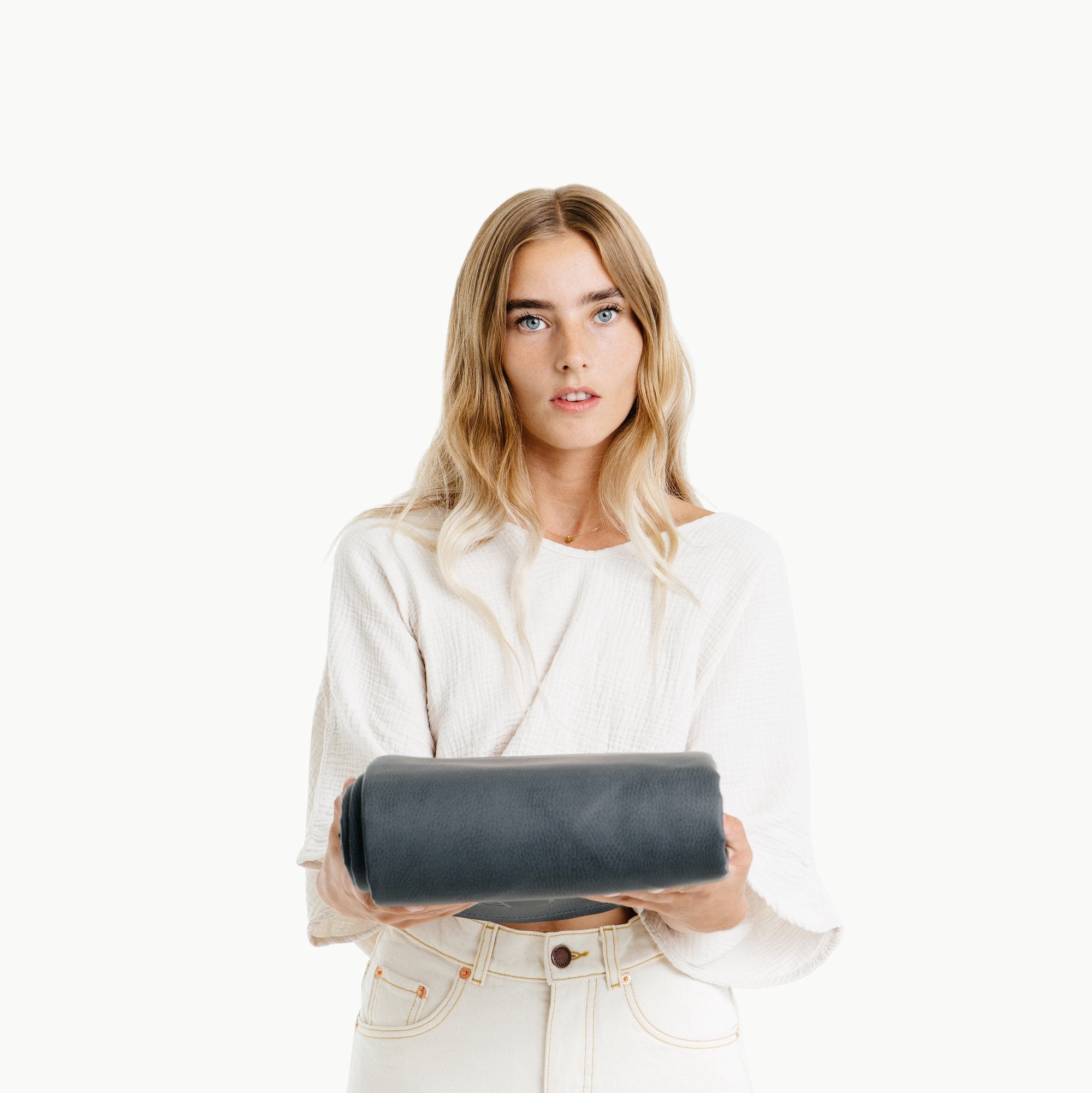 Raven@Woman holding a folded Raven Maxi Mat