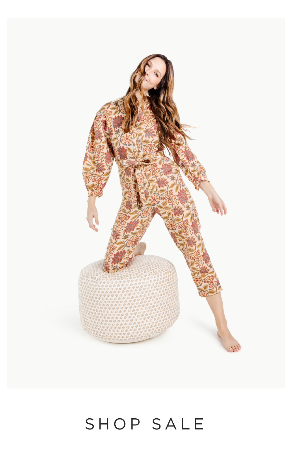 woman kneeling on a pouf