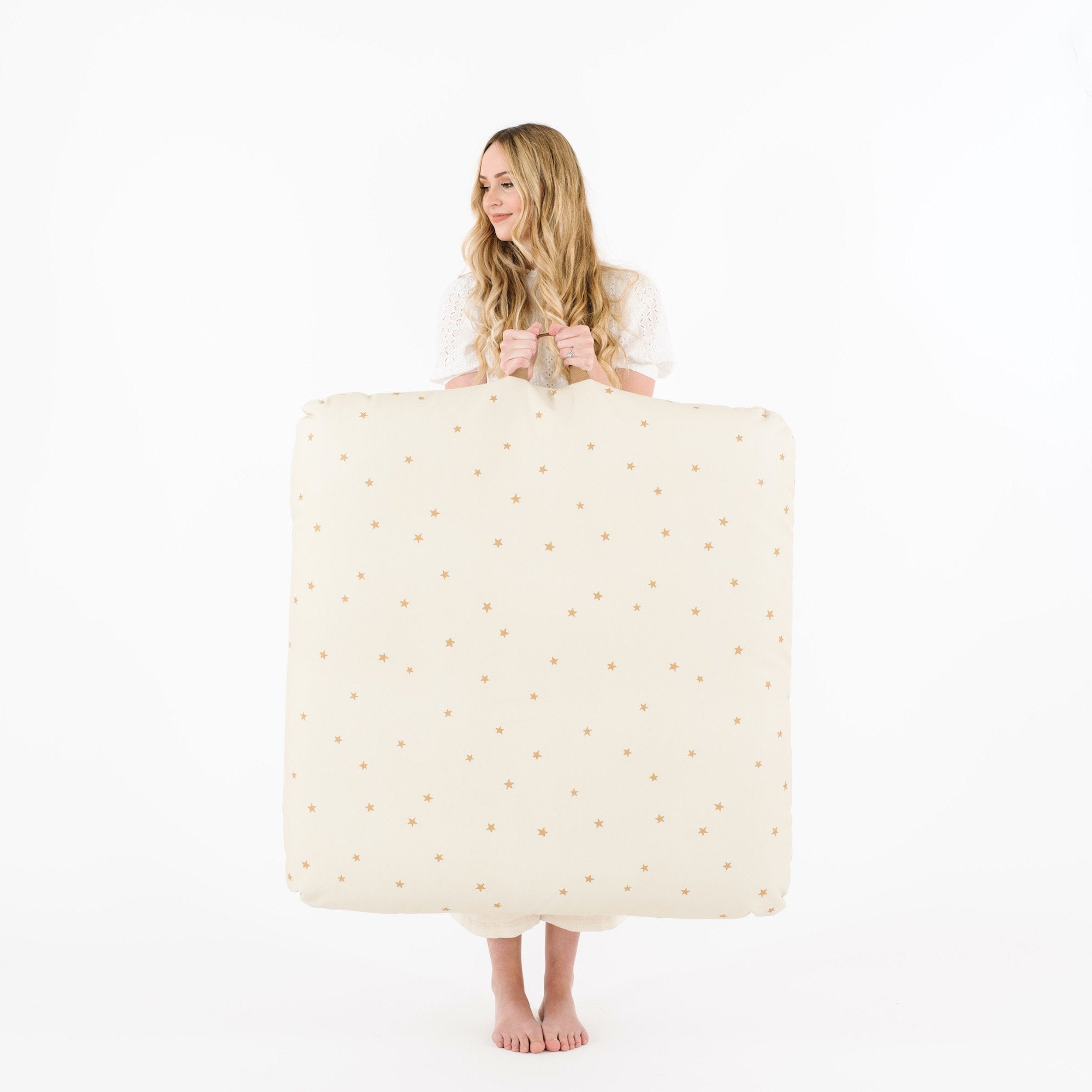 Stars (on sale) / Square@Woman holding the Stars Square Floor Cushion
