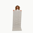 Stone Stripe (on sale)@Woman holding the large stone stripe home mat