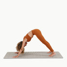 Stone Stripe (on sale)@Woman doing yoga on the large stone stripe home mat