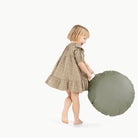 Thyme / Circle@Kid holding the Thyme Mini Circle Floor Cushion