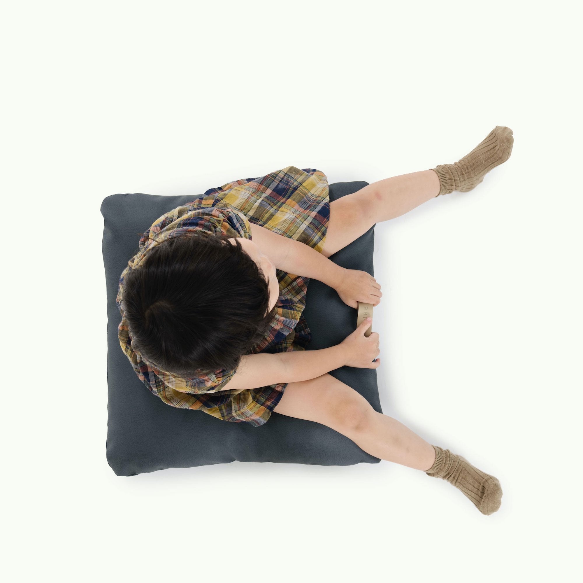 Nightfall (on sale) / Square@overhead of kid sitting on the nightfall mini square floor cushion 