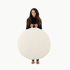 Ivory / Circle@woman holding the ivory circle floor cushion