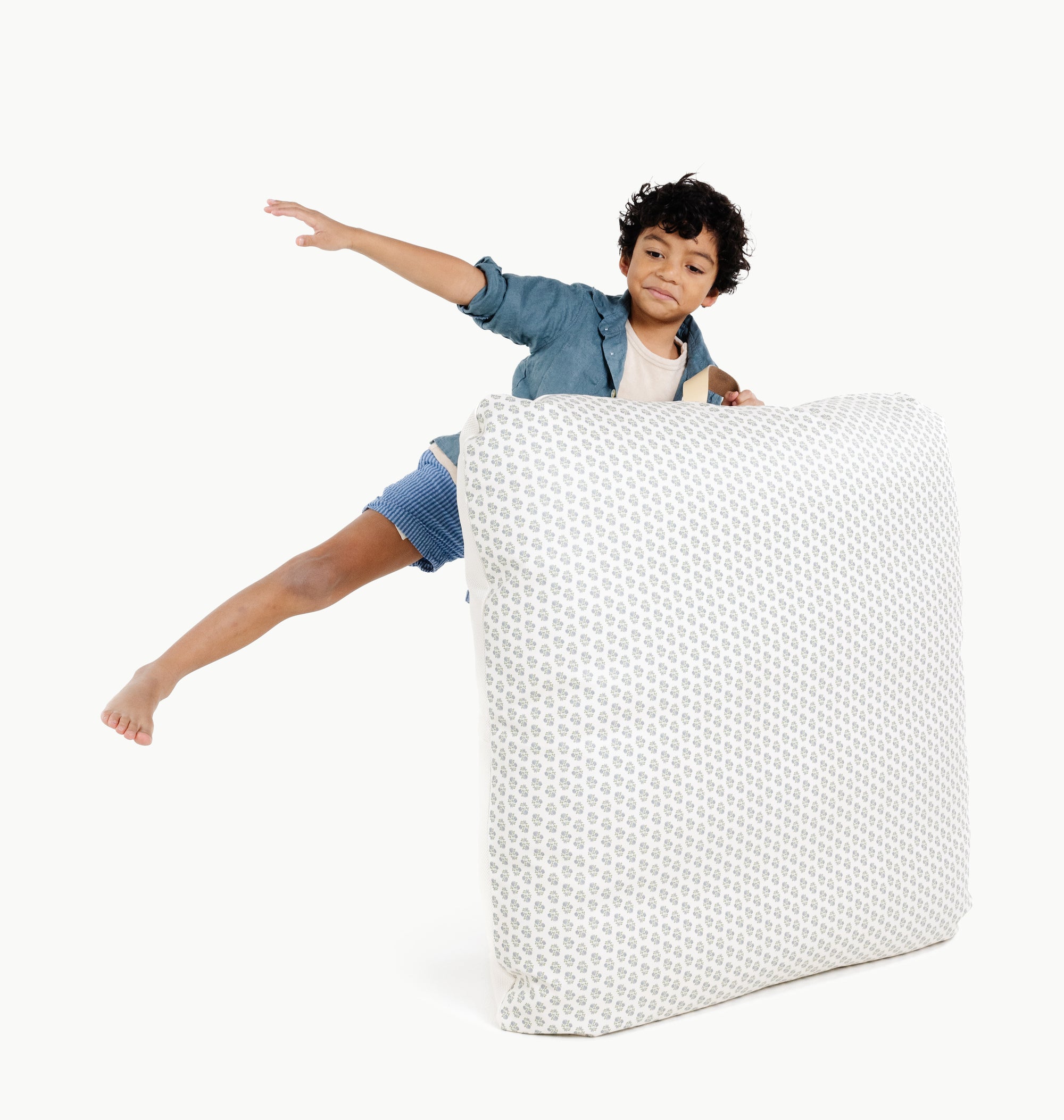 Meadow / Square@kid holding the meadow square floor cushion