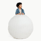 Meadow / Circle@kid holding the meadow circle floor cushion