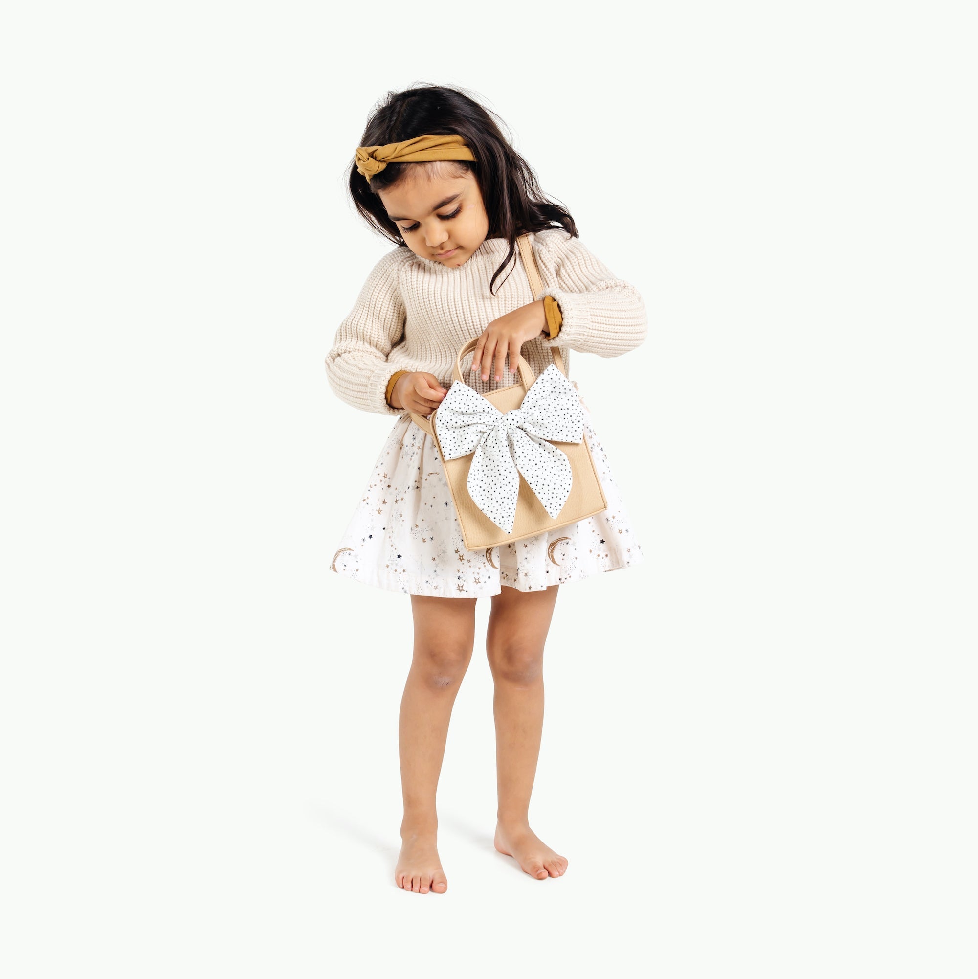 Untanned@little girl playing with the untanned children's purse