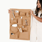 Camel@Woman holding Dawn Wall Tidy with objects in pockets