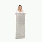 Stone Stripe (on sale)@woman holding the stone stripe medium home mat